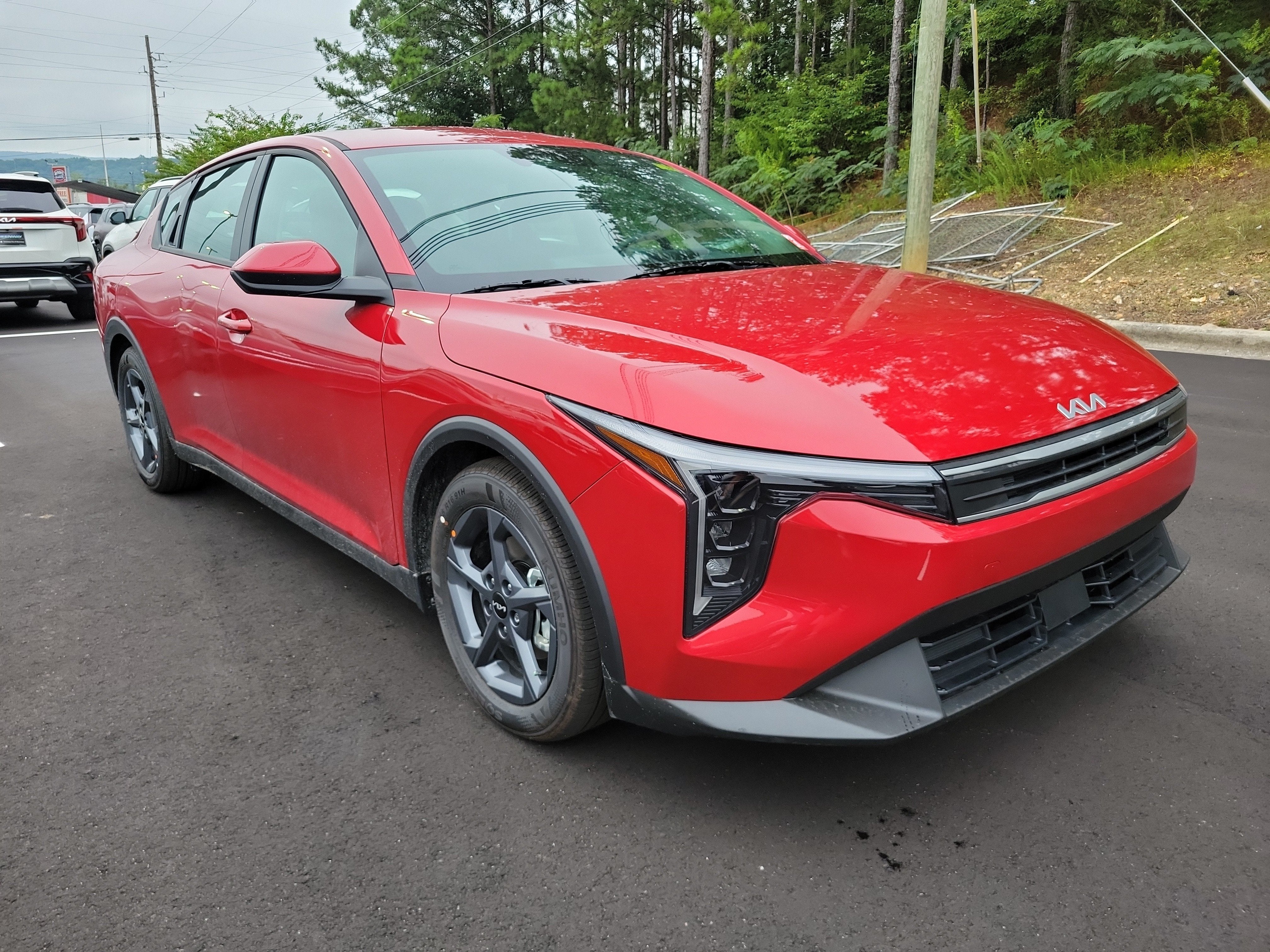 2026 Kia K4 LXS in Currant Red — front three-quarter view