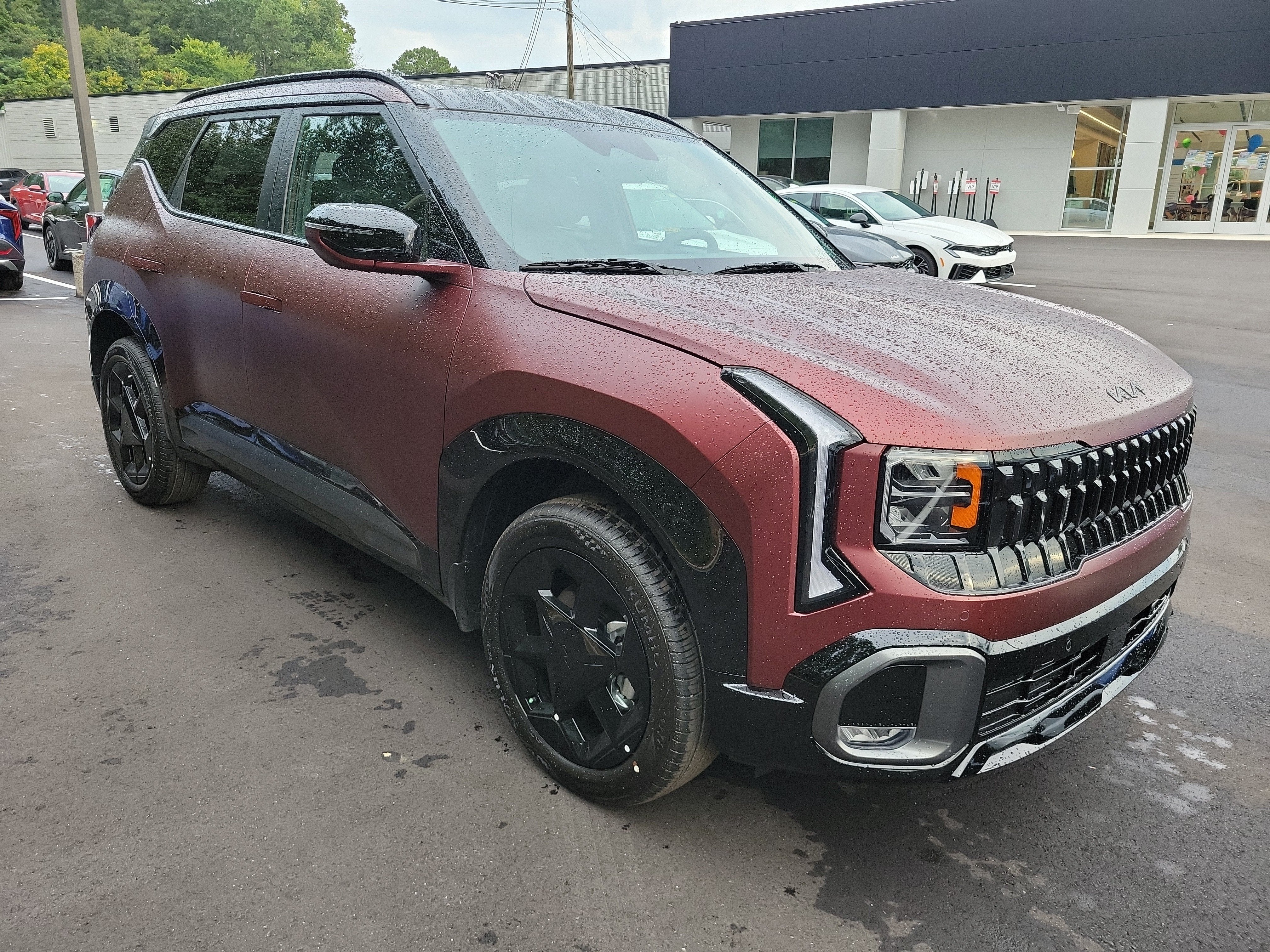 2027 Kia Seltos X-Line in Magma Red Matte — front three-quarter view